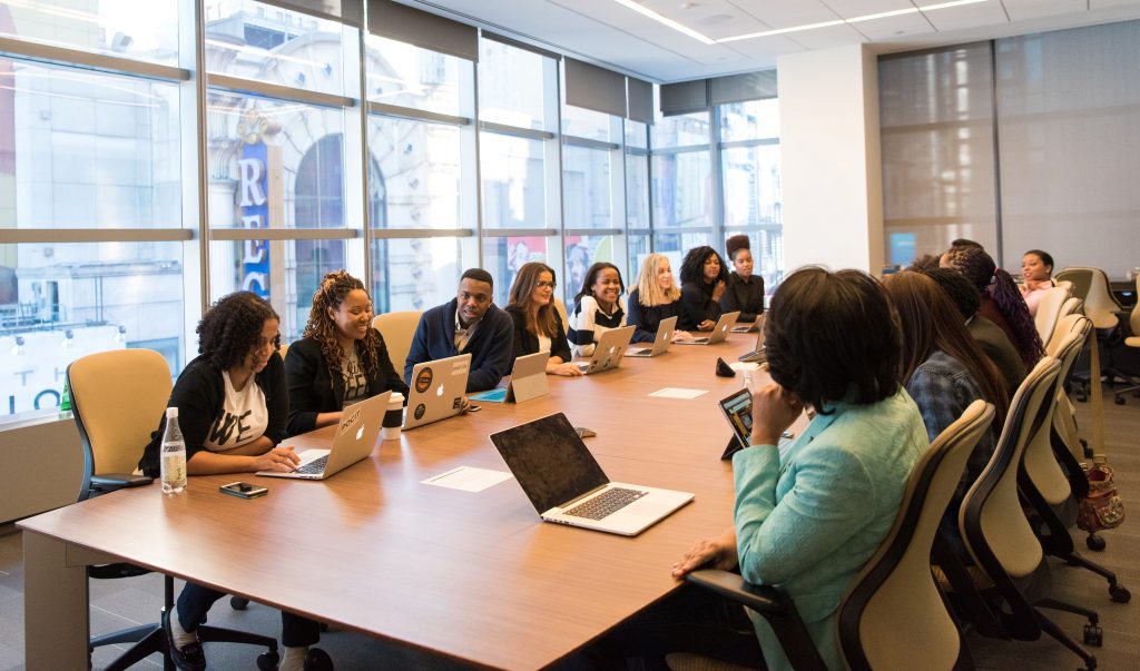 Photo of a meeting in a workplace, which invites people from diverse background to disscus a topic